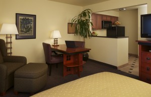 interior hotel suite with dining area and kitchen