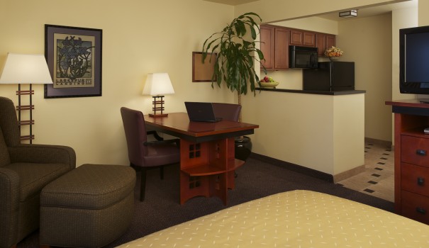 interior hotel suite with dining area and kitchen